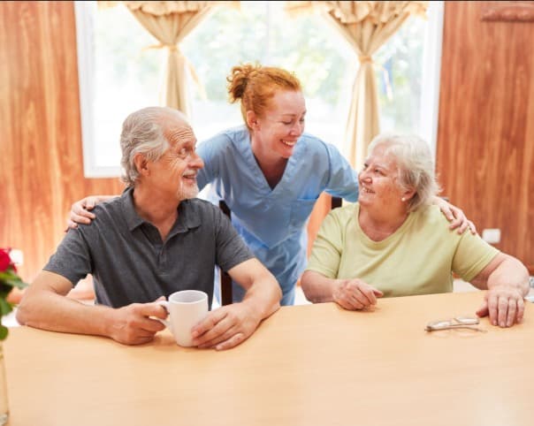 Support worker spending time with an older couple