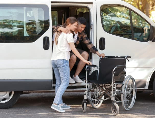 Support worker assisting with accessible transport